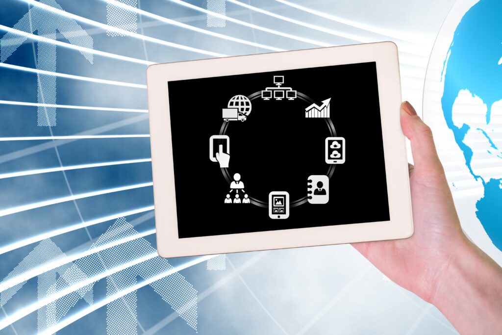 Hand holding tablet showing connected business technology flow with app icons