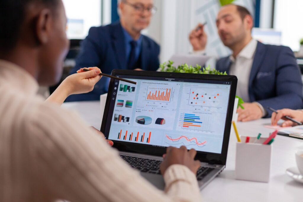 ERP Software Explained: Architecture Modules and System Design (2026) ERP software dashboard showing business analytics and data visualization during an enterprise team meeting