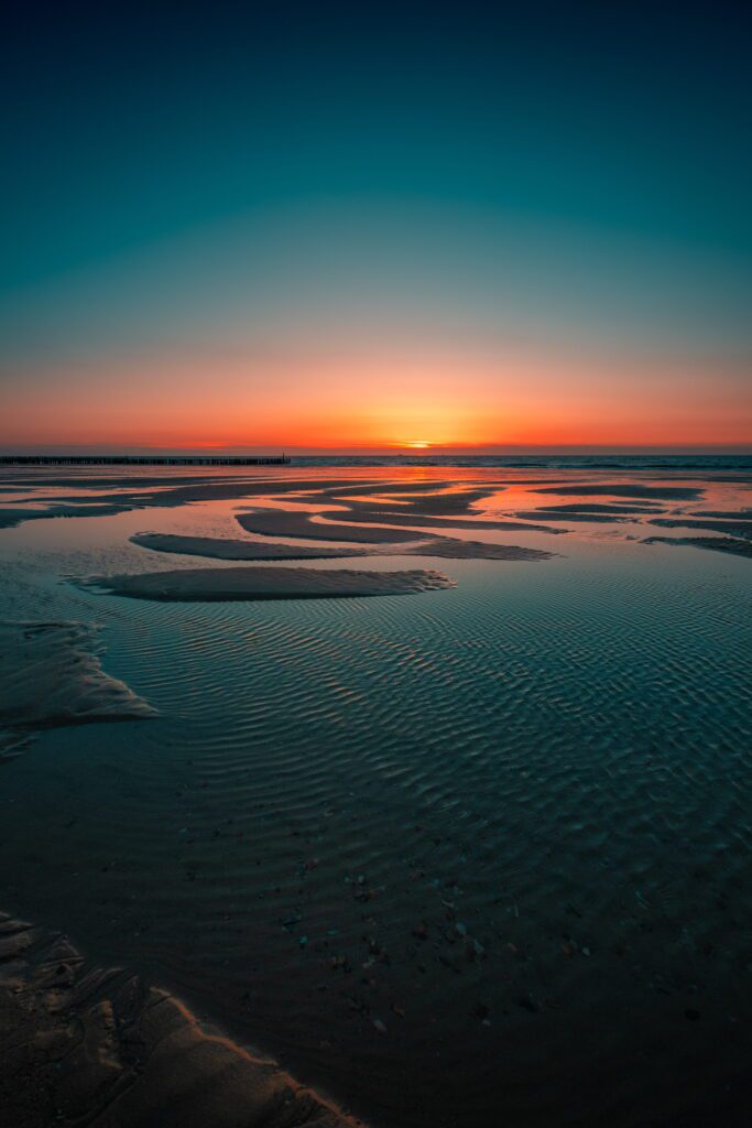 iPhone 16 Pro Max lock screen wallpaper sunset sea reflection Domburg Netherlands landscape