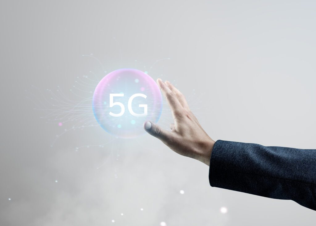 Business professional holding a 5G hologram representing 5G network security and next-generation wireless technology