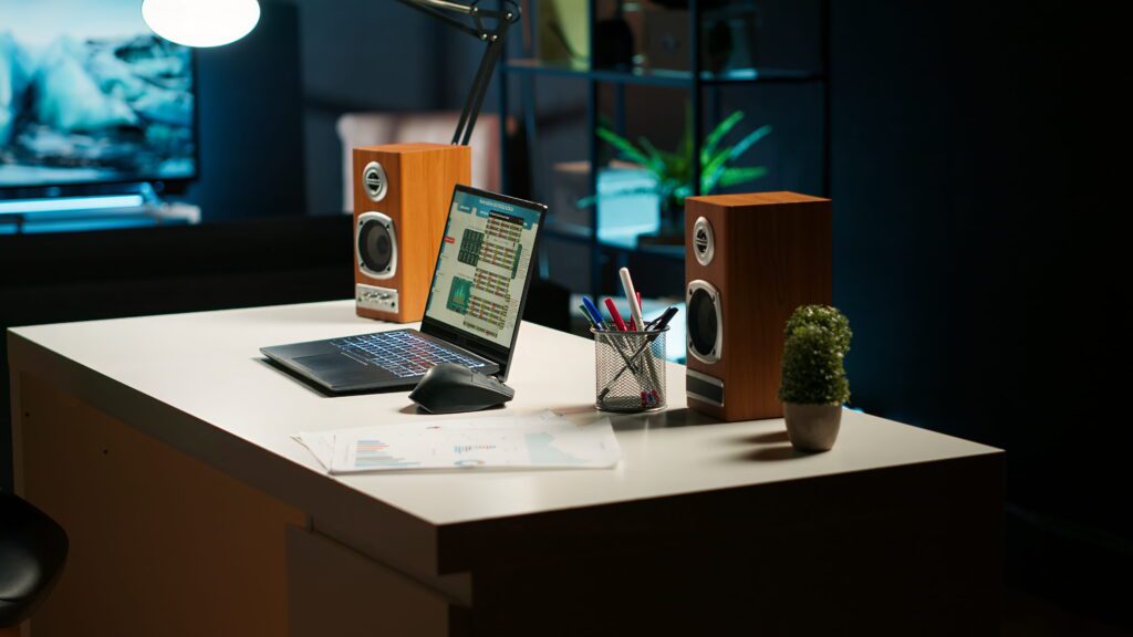 Clevo NH70 gaming laptop on desk with dark ambient lighting showing screen display