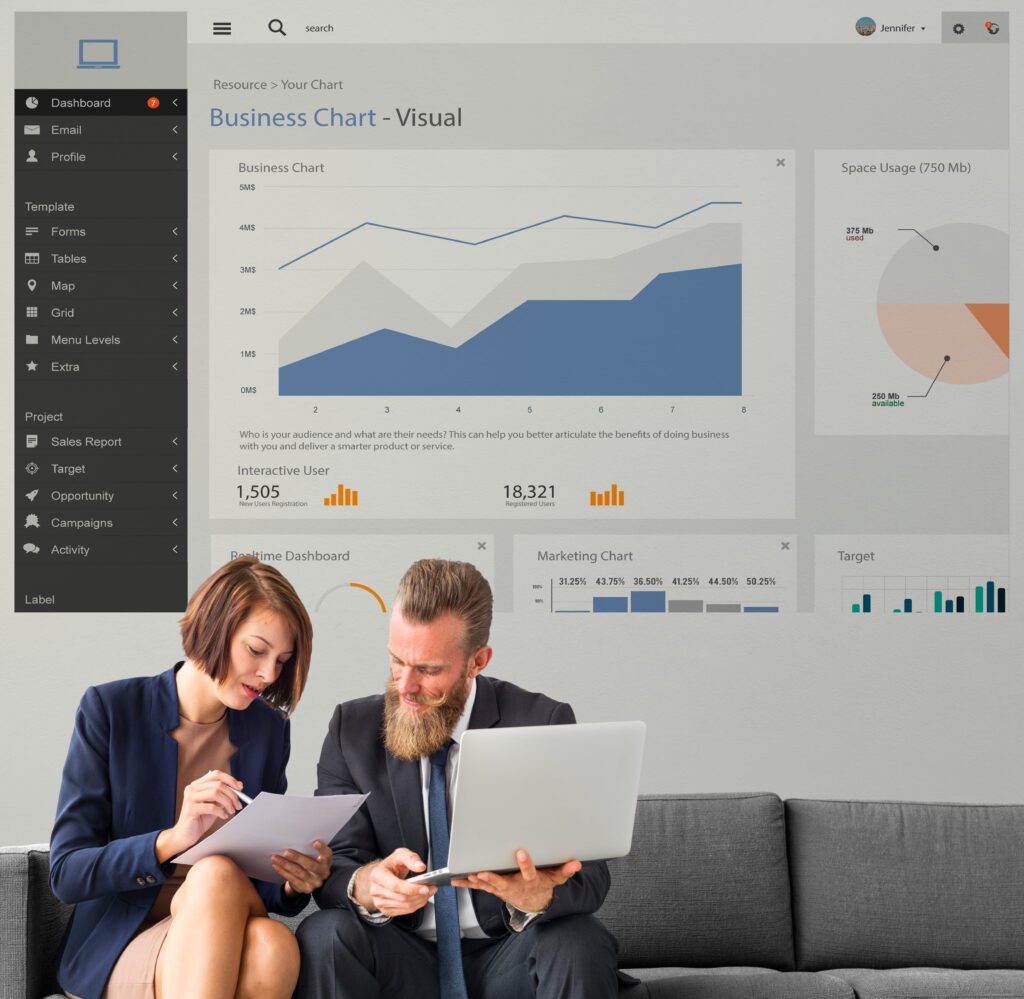 Business professionals reviewing CRM software dashboard with sales reports, marketing charts, and real-time analytics on laptop
