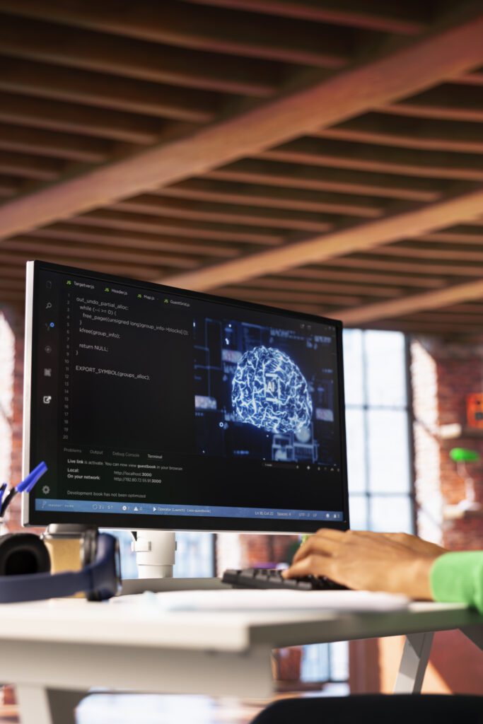 Developer working to install Claude Code with terminal and AI code editor open on monitor